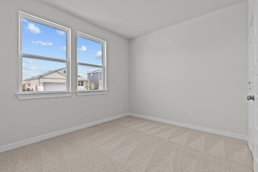 A room with a window and a carpet.