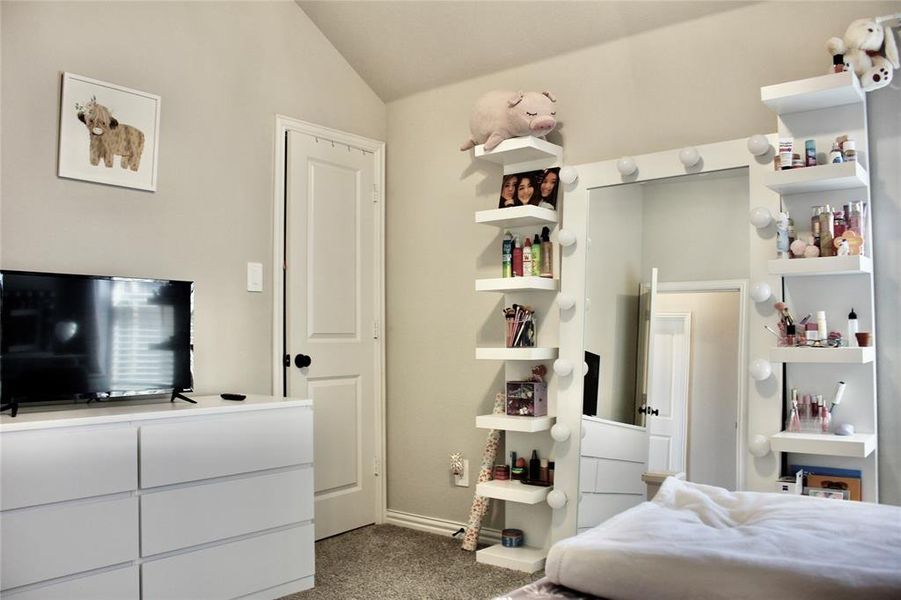 Bedroom with light carpet and lofted ceiling Bedroom with light carpet and lofted ceiling