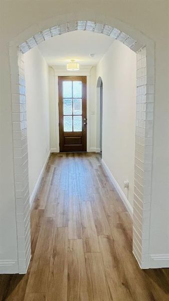 Hall featuring light wood-type flooring