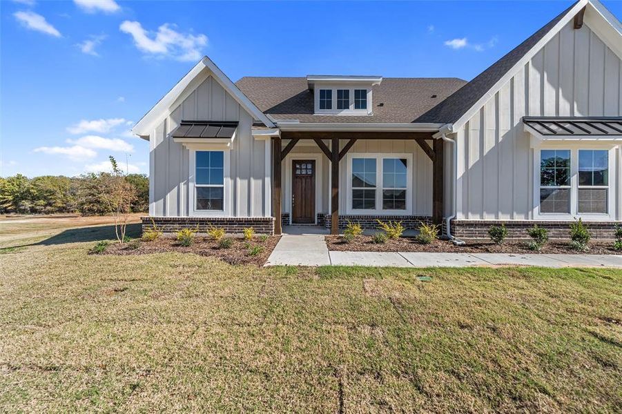 Front exterior of a new home in Oak Grove Addition, Springtown, TX, highlighting curb appeal (Image 25). Front exterior of a new home in Oak Grove Addition, Springtown, TX, highlighting curb appeal (Image 25).