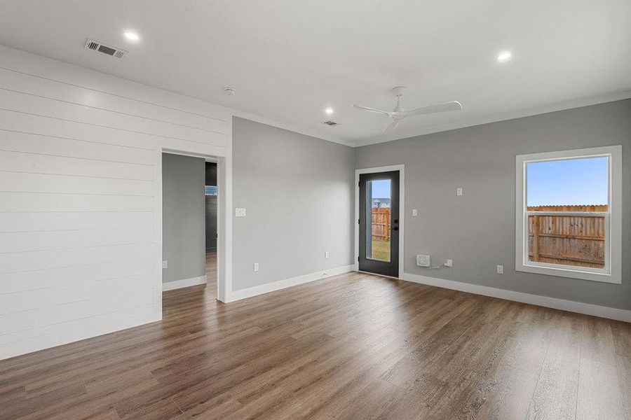 Unfurnished room featuring wood finished floors, recessed lighting, ornamental molding, and ceiling fan