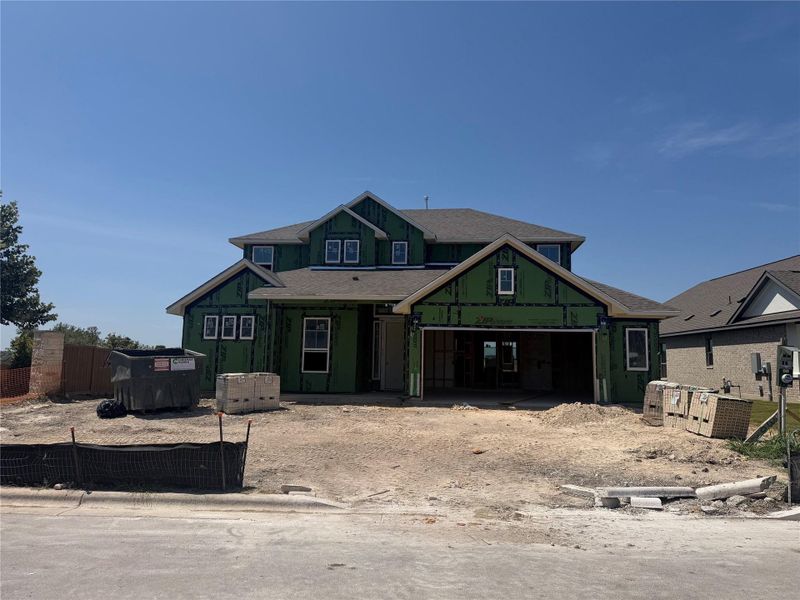 Progress continues on this new construction home showcasing prominent gables and an attached garage.