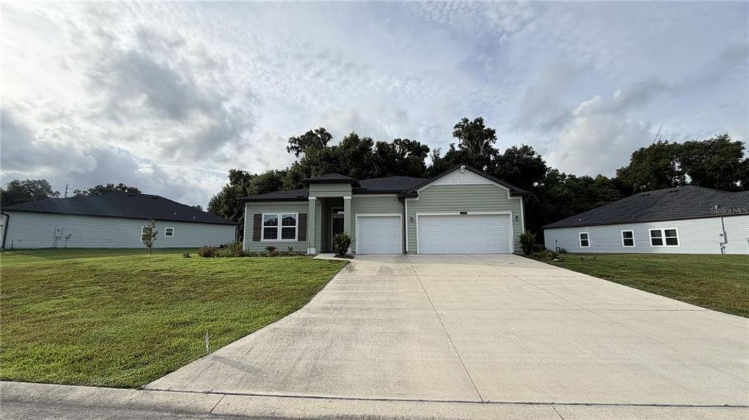 Front exterior of a new home in Grand Park North, Dunnellon, FL, highlighting curb appeal (Image 15).