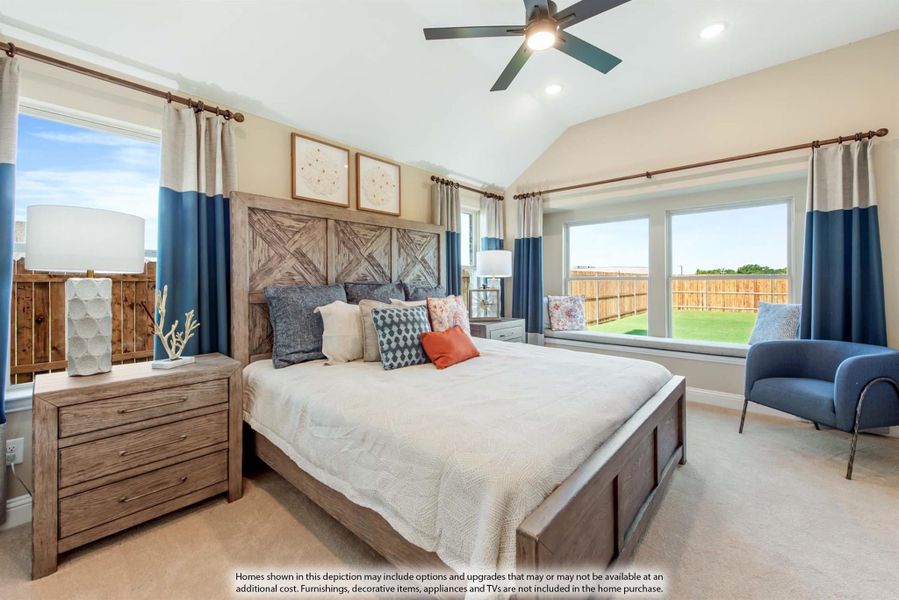 Bedroom with vaulted ceiling, wood panel headboard, ceiling fan, and large windows with blue curtains