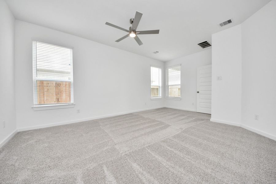Another perspective unveils a comprehensive view of the serenity and comfort this primary suite offers. Sample photo of completed home with similar floor plan. Actual colors and selections may vary.