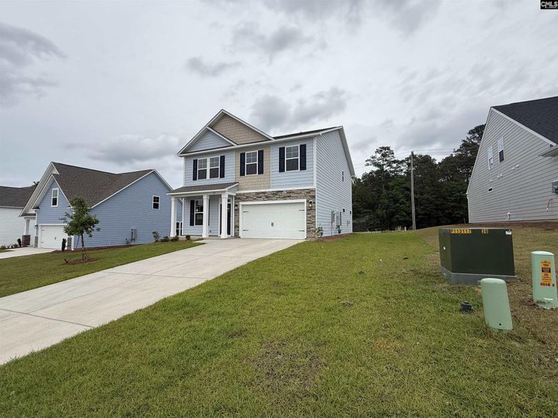 Front exterior of a new home in Cottages at Roofs Pond, West Columbia, SC, highlighting curb appeal (Image 26).
