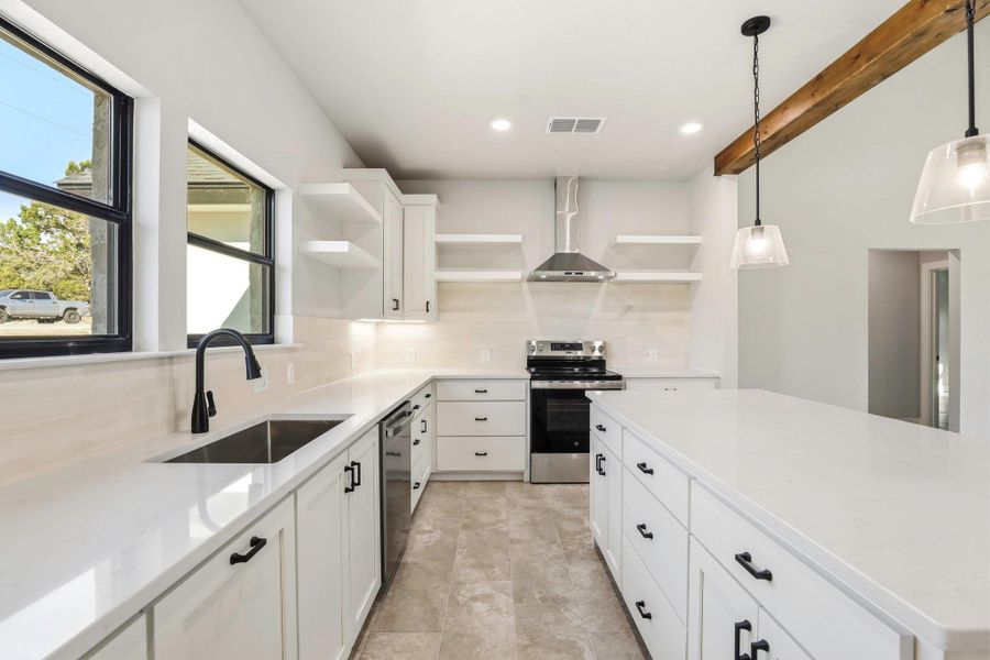A well-appointed kitchen features crisp white cabinetry, luminous countertops, and modern stainless appliances, creating an inviting culinary space. A well-appointed kitchen features crisp white cabinetry, luminous countertops, and modern stainless appliances, creating an inviting culinary space.