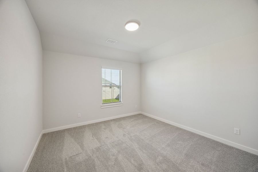 Bedroom in the Wimbledon home plan by Trophy Signature Homes – REPRESENTATIVE PHOTO