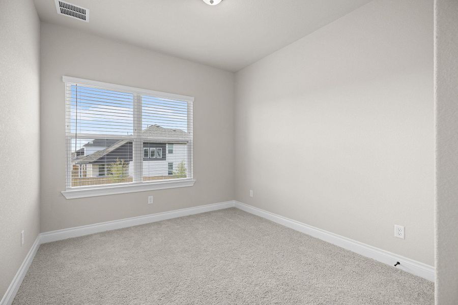 Spare room with light carpet and baseboards