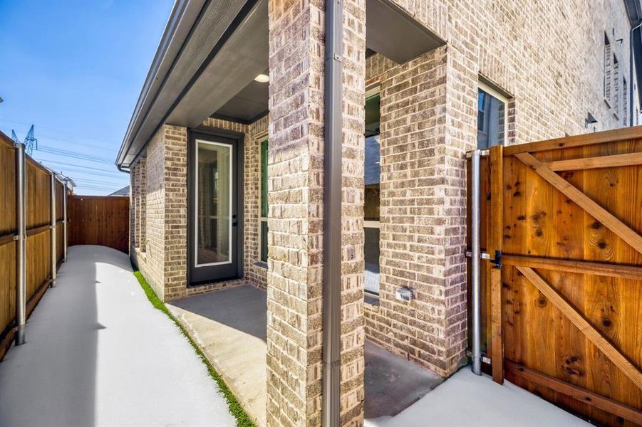 Exterior details and patio area of a home in Castle Hills Northpointe - Townhomes, Lewisville (Image 3).