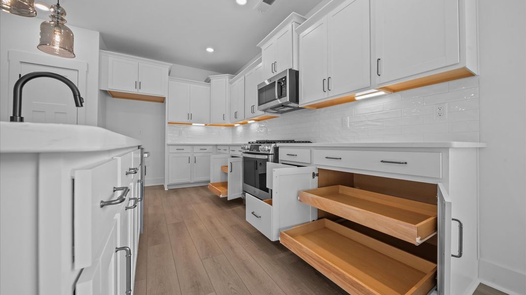 Highly skilled design choices create a clean, open kitchen with a central island Highly skilled design choices create a clean, open kitchen with a central island