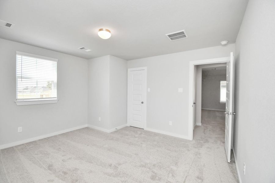 Generously sized secondary bedrooms featuring spacious closets, soft and inviting carpeting underfoot, large windows allowing plenty of natural light, and the added touch of privacy blinds for your personal retreat. Sample photo of completed home with similar floor plan. Actual colors and selections may vary.