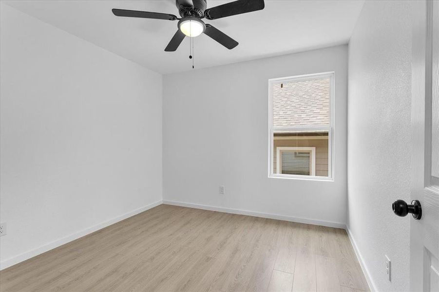 Spare room featuring ceiling fan and light hardwood / wood-style flooring