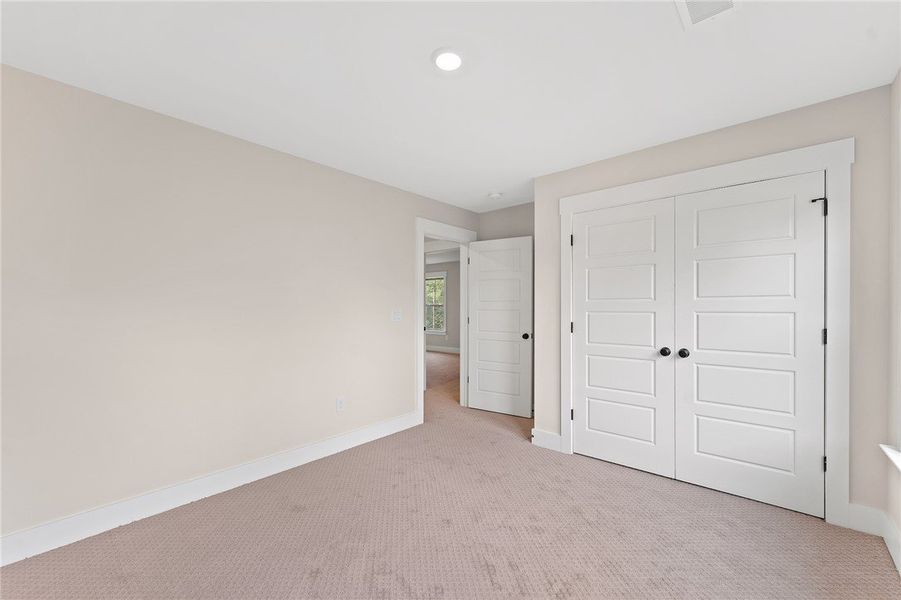 This spacious bedroom offers ample natural light a
