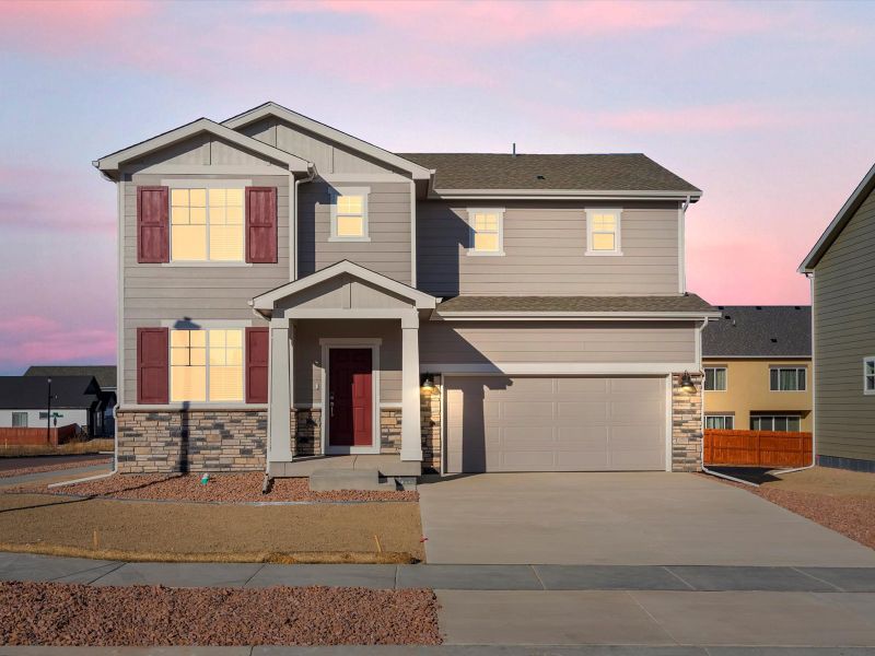 Front exterior of a new home in Meridian Ranch, Peyton, CO, highlighting curb appeal (Image 1). Front exterior of a new home in Meridian Ranch, Peyton, CO, highlighting curb appeal (Image 1).