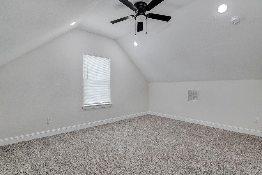 Bedroom 4 or Family Room with carpet, ceiling fan, and vaulted ceiling