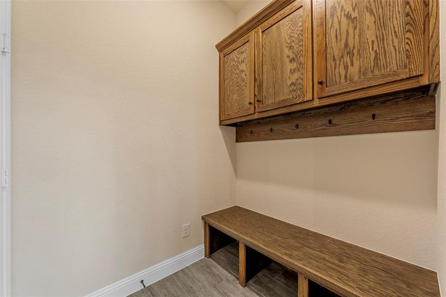 Mudroom featuring baseboards and light wood-style floors