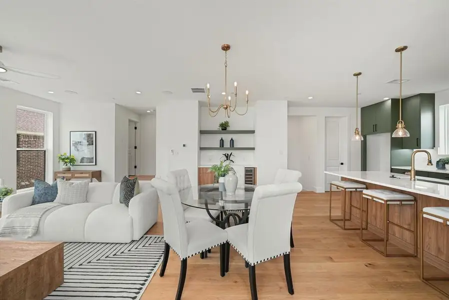 Spacious open-concept living area featuring light wood-finish flooring, recessed lighting, and white walls Spacious open-concept living area featuring light wood-finish flooring, recessed lighting, and white walls