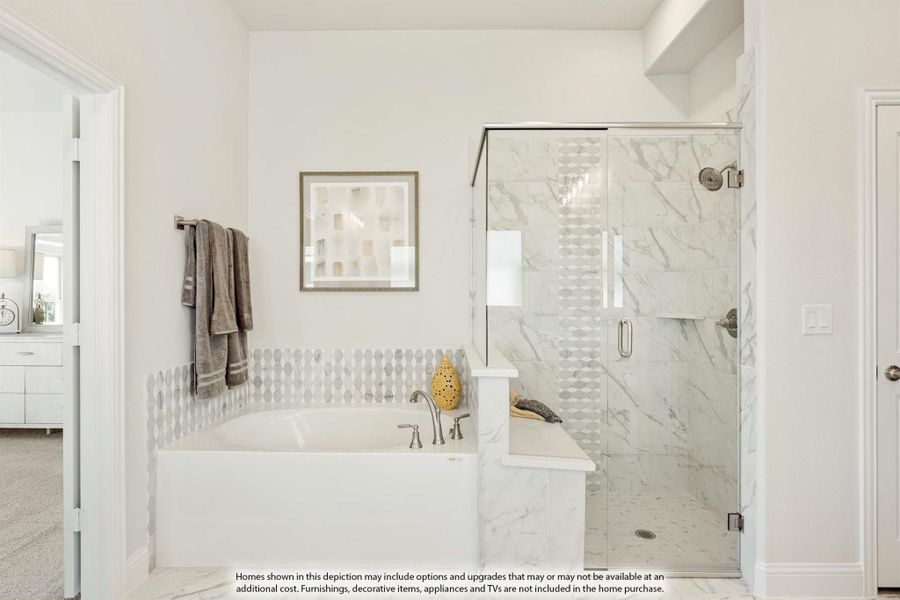 Bathroom with soaking tub, glass-enclosed marble shower, and decorative tile accents