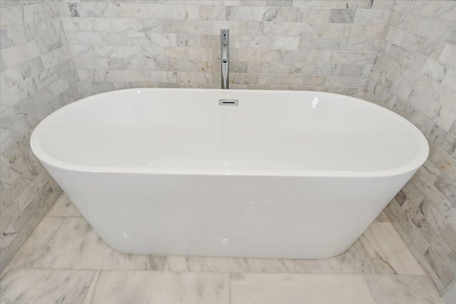 Separate Soaking Tub Surrounded by Marble.