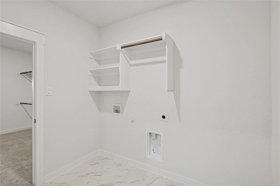 Washroom featuring gas dryer hookup, hookup for an electric dryer, light carpet, and hookup for a washing machine