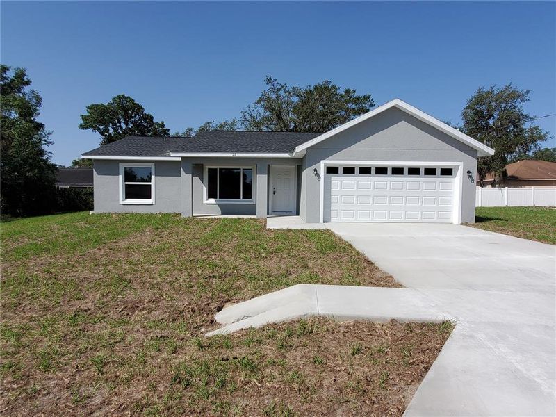 Front exterior of a new home in , Ocklawaha, FL, highlighting curb appeal (Image 17).