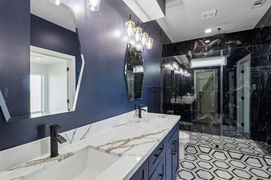 Custom primary bath with rain shower head and double vanities