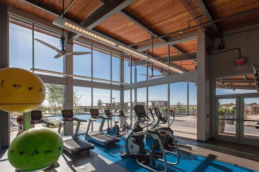 Workout area featuring french doors, a wall of windows, a high ceiling, and wooden ceiling