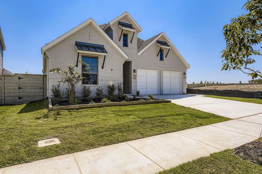 View of front of home with concrete driveway, a garage, and brick siding View of front of home with concrete driveway, a garage, and brick siding