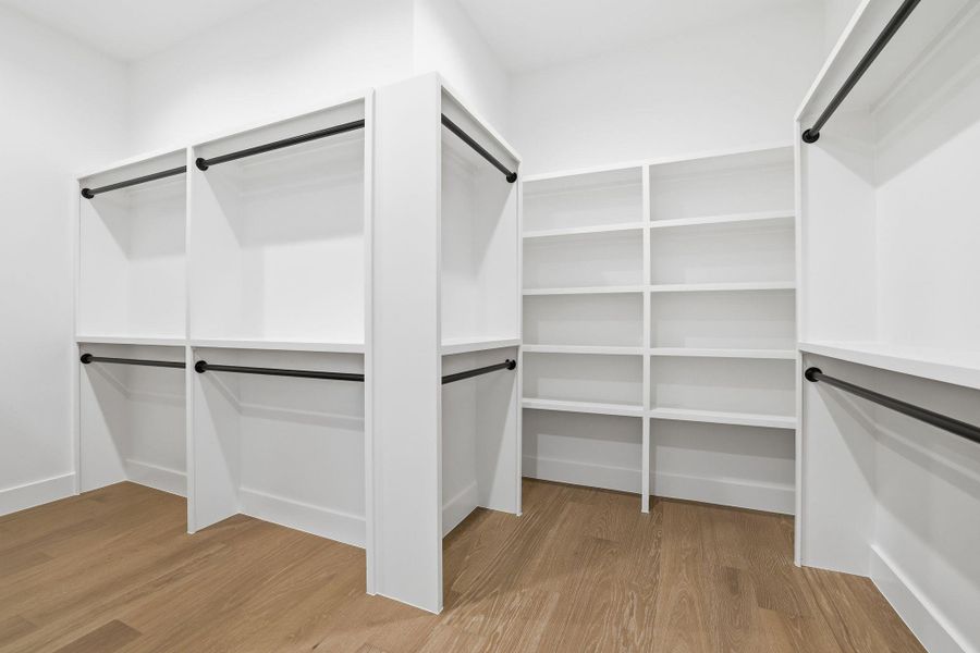 Walk in closet featuring light wood-style flooring
