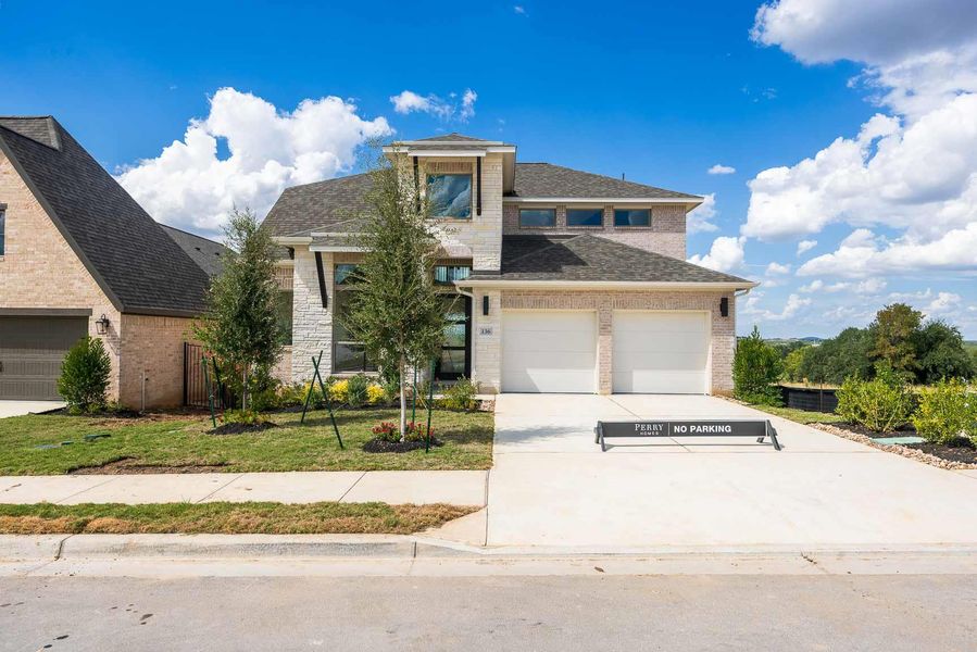View of front of property with a shingled roof, driveway, and brick siding View of front of property with a shingled roof, driveway, and brick siding