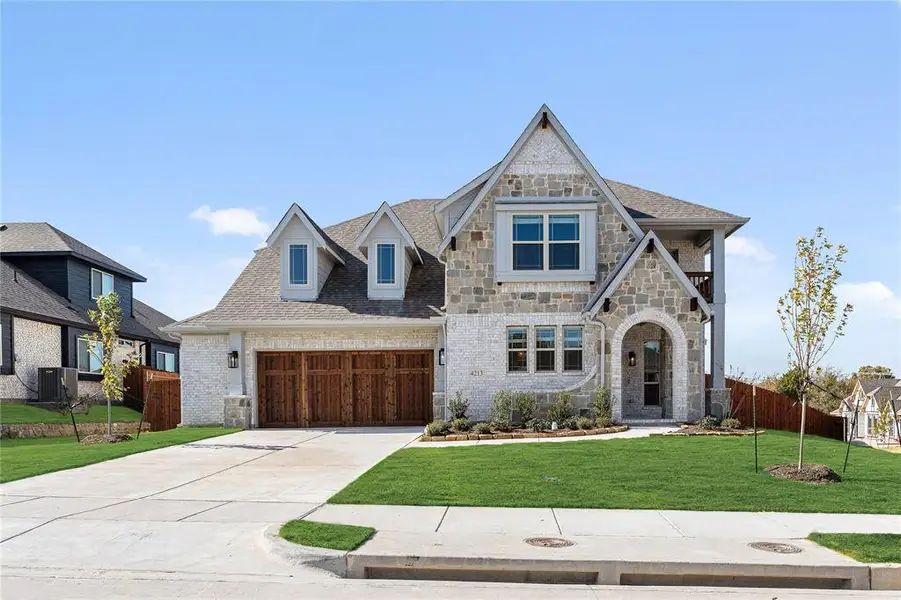 Front exterior of a new home in Ridgepoint, Midlothian, TX, highlighting curb appeal (Image 1).