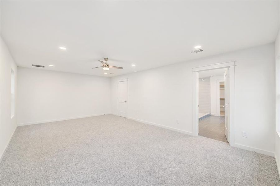 Spare room with light carpet, visible vents, recessed lighting, and ceiling fan