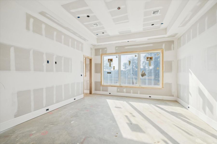 The game room showcases an open, flexible layout with recessed lighting and plenty of space for media, play, or a second living zone. The generous window line brings in soft natural light throughout the day. A true downstairs retreat designed for both entertainment and relaxation.