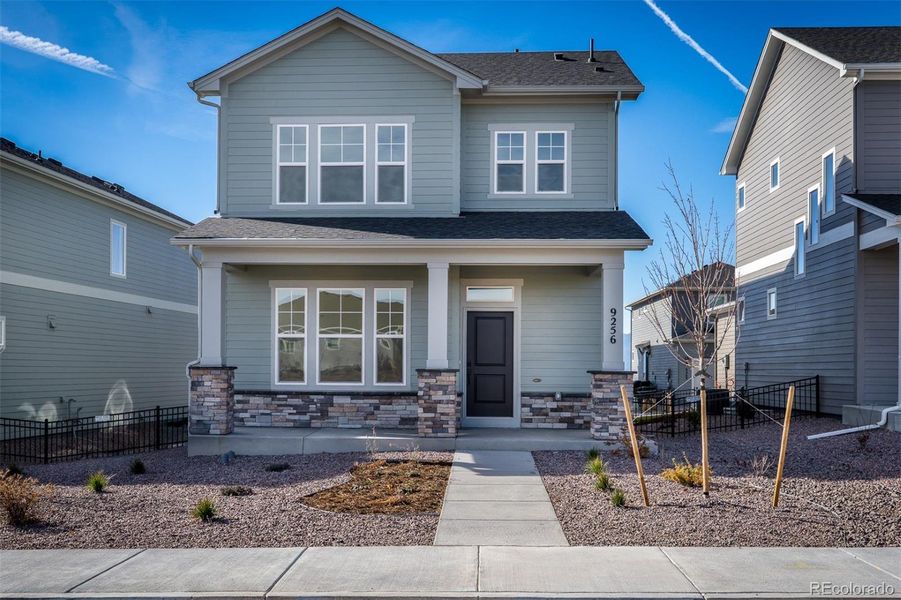 Front exterior of a new home in Revel Crossing at Wolf Ranch – The Outlook Collection, Colorado Springs, CO, highlighting curb appeal (Image 2).