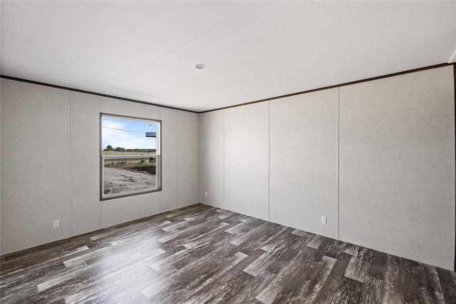 Spare room with dark wood-type flooring