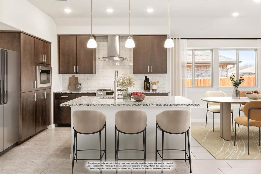 Kitchen with dark wood cabinets, granite island with three bar stools, and stainless steel range hood