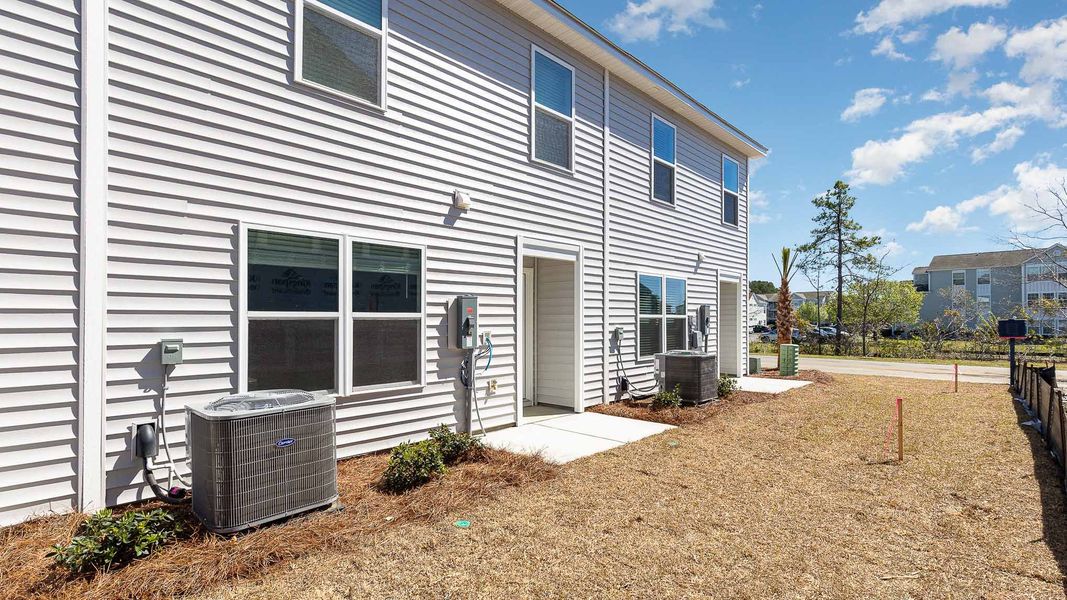 Front exterior of a new home in The Cove at Glenns Bay, Surfside Beach, SC, highlighting curb appeal (Image 2).