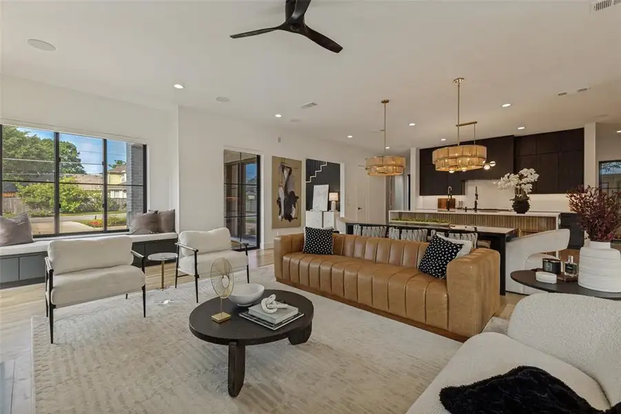 Open-concept living area with light wood-finish flooring Open-concept living area with light wood-finish flooring
