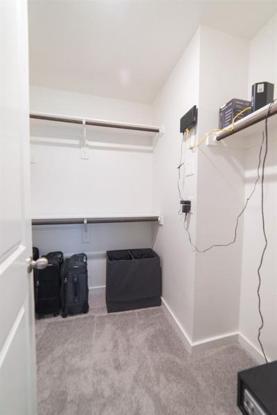 Spacious closet with light colored carpet