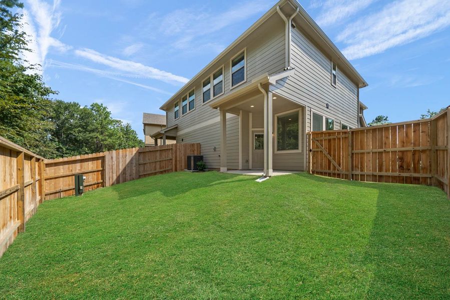 Exterior details and patio area of a home in Woodforest, Montgomery (Image 24).
