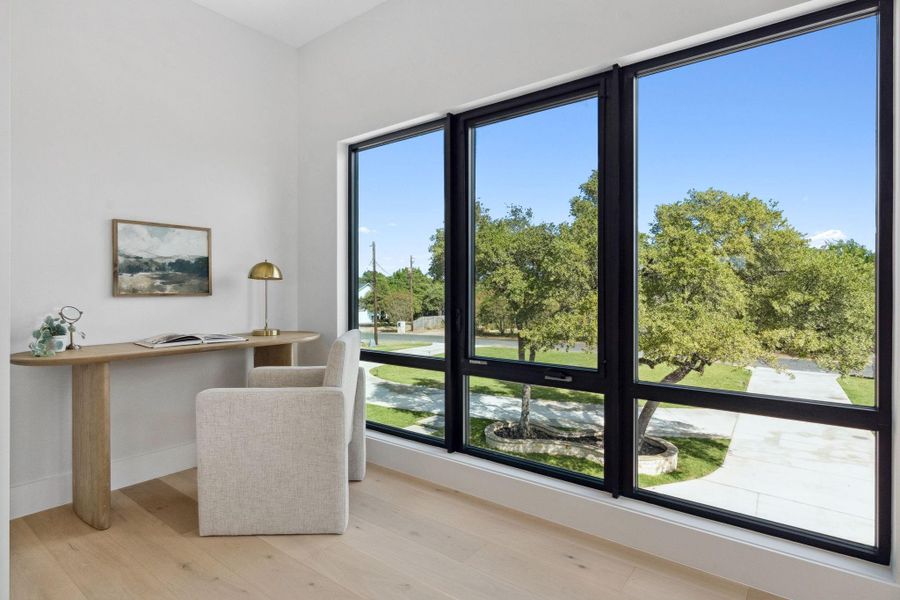 A cozy office nook with breathtaking views of the grand, sprawling oaks out front.