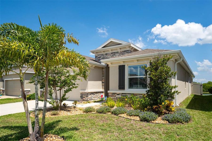 Front exterior of a new home in Evergreen, Bradenton, FL, highlighting curb appeal (Image 1). Front exterior of a new home in Evergreen, Bradenton, FL, highlighting curb appeal (Image 1).