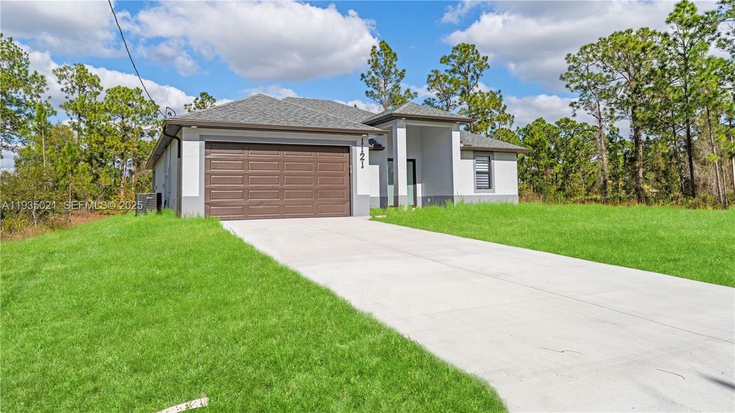 Front exterior of a new home in , Lehigh Acres, FL, highlighting curb appeal (Image 19).