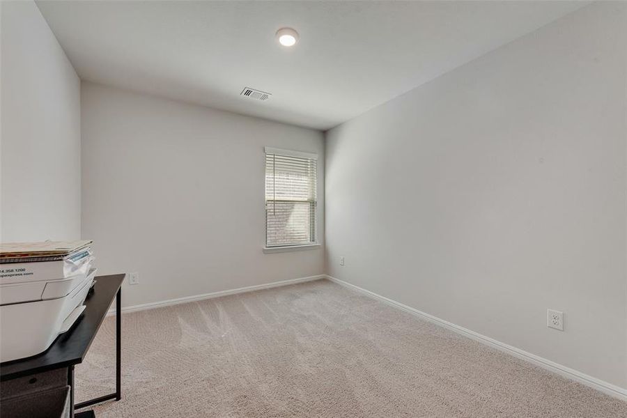 Unfurnished office featuring light colored carpet and baseboards Unfurnished office featuring light colored carpet and baseboards