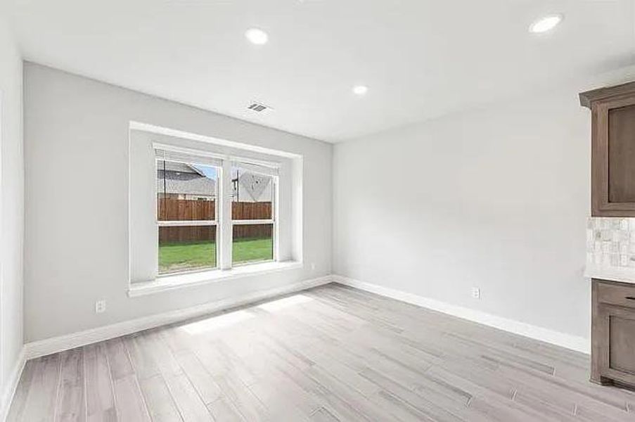 Unfurnished living room featuring light wood-style flooring, baseboards, and recessed lighting