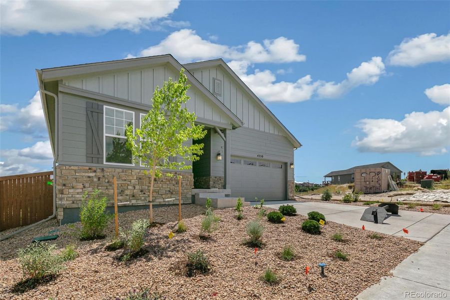 Front exterior of a new home in Terrain Oak Valley, Castle Rock, CO, highlighting curb appeal (Image 22).