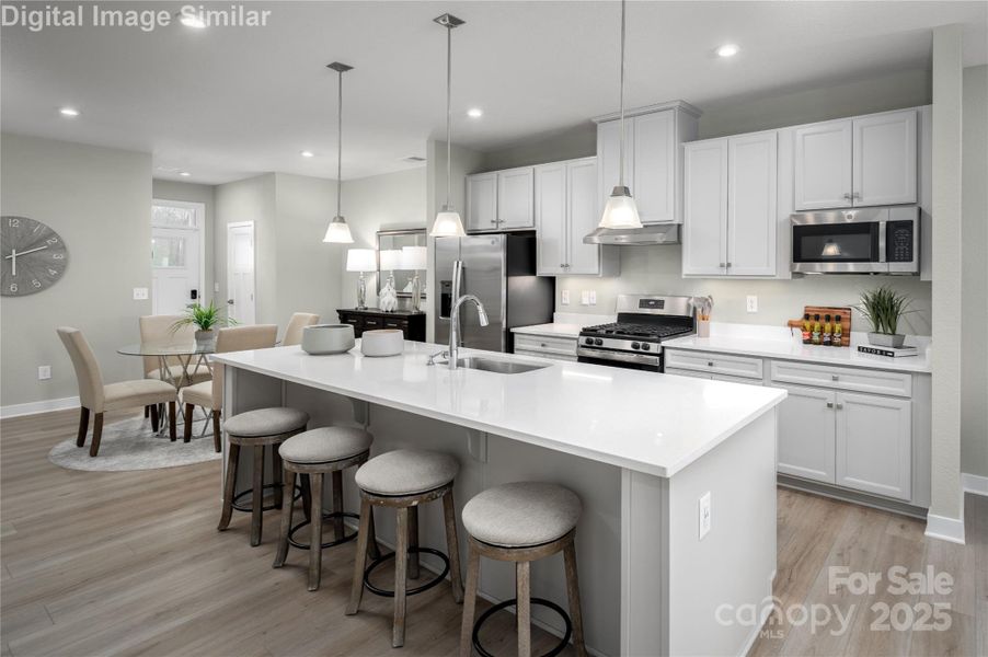 A home that greets you with warmth from the welcoming entrance foyer to the heart of the kitchen. The open layout flows into a stylish dining area and spacious island, offering seating for at least 8 guests. It’s always “din din” time in this vibrant, social space made for connection, comfort, and celebration.