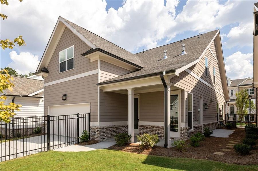 Front exterior of a new home in Evanshire Single Family, Duluth, GA, highlighting curb appeal (Image 25). Front exterior of a new home in Evanshire Single Family, Duluth, GA, highlighting curb appeal (Image 25).