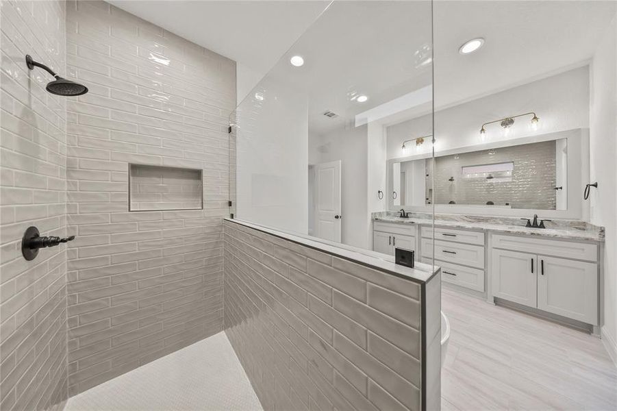 Full bathroom with vanity, a walk in shower, recessed lighting, and light wood-type flooring